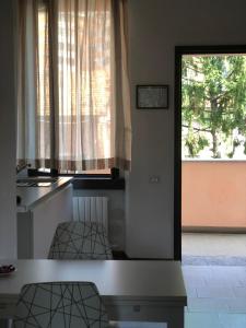 サン・ジュリアーノ・ミラネーゼにあるB&B La Ruota Milanoのキッチン(テーブル、椅子2脚付)、窓が備わります。