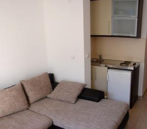 a living room with a couch and a kitchen at NEW STUDIO MUO in Kotor