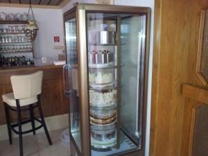 a glass refrigerator with some food inside of it at Landgasthof Zum Heiligenberg in Sontra