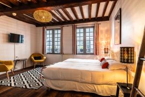 Postel nebo postele na pokoji v ubytování Hotel Le Port Neuf