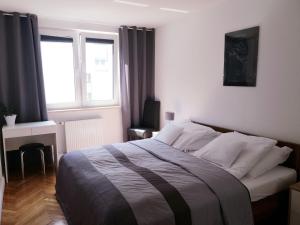 Posteľ alebo postele v izbe v ubytovaní Apartament Kamienna Gdynia