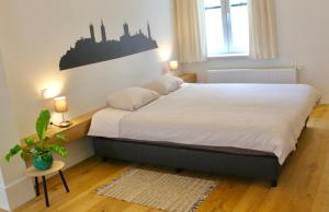 a bedroom with a bed and a plant and a window at Bennestay in Ghent