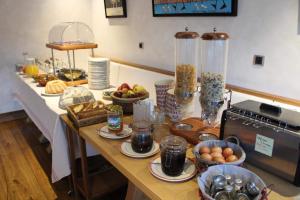 a table with a bunch of food on it at Hôtel-Chalet Les Ecureuils Spa & Sauna in Le Grand-Bornand