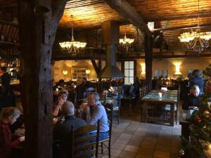 a group of people sitting at tables in a restaurant at ANVIBE 1 in Lathum