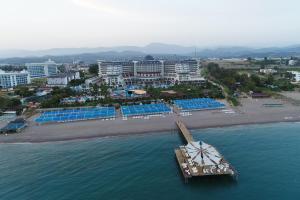 an aerial view of a beach with a boat in the water at Seaden Sea Planet Resort & Spa All Inclusive in Kızılot