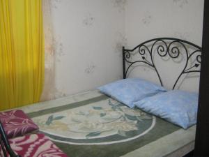 a bedroom with a bed with a painting on it at Apartment in Pyatigorsk in Pyatigorsk