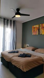 a bedroom with two beds and a ceiling fan at Calle Atlantico 108 1b Appartement in Sucina +44 photos