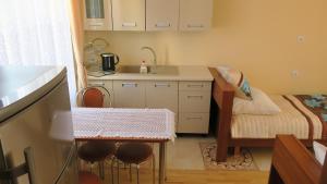 a small kitchen with a sink and a bed at Rodzinny dom. in Augustów