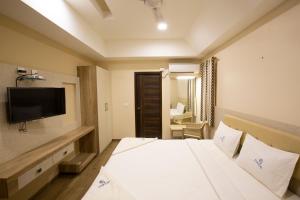 Ponnis Hotel客房内的一张或多张床位