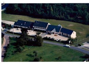 an overhead view of a large building with black roofs at Logis Hotel Restaurant de l'Abbaye in Ferrières