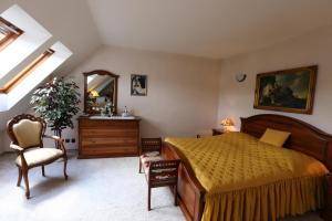 a bedroom with a bed and a dresser and a mirror at Penzion Panda in Turčianske Teplice