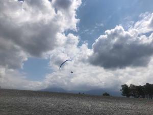 a person flying a kite in a cloudy sky at Dito House in Kobuleti