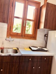 a kitchen with a sink and a window at Batistas Apartments in Naousa +149 photos