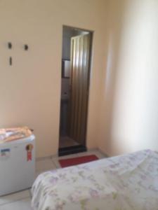 a bedroom with a bed and a mirror and a door at Pousada águas belas in Carolina +13 photos