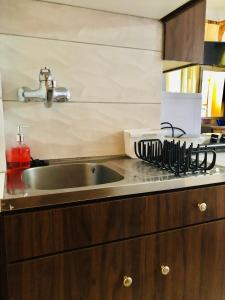 a kitchen with a sink and a counter top at Batistas Apartments in Naousa