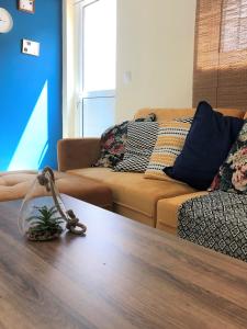 a living room with a table and a couch at Boho Apartment near Athens Airport in Spáta