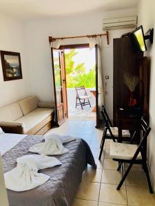 a bedroom with a bed and a living room at Batistas Apartments in Naousa