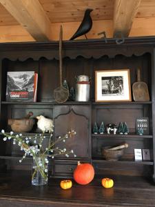 a shelf with a vase of flowers on a table at Chalet ToutBlanc in Servoz +30 photos
