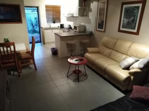 a living room with a couch and a table at Mandurah Central Estuary Soldiers cove Townhouse in Mandurah