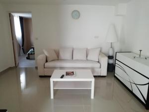 a living room with a couch and a coffee table at Chez Laurent in Bergerac