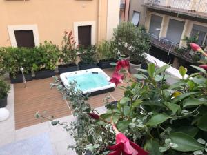 an apartment patio with a swimming pool and plants at Casa Diverio in Stresa