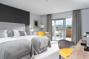 a hotel room with two beds and a balcony at Killeavy Castle Estate in Meigh