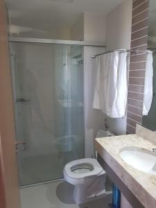 a bathroom with a shower and a toilet and a sink at Park Veredas in Rio Quente