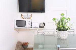TV a/nebo společenská místnost v ubytování Rochinha Cozy Home