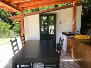 a kitchen with a black table and chairs on a patio at Alloggio Rurale in Terni
