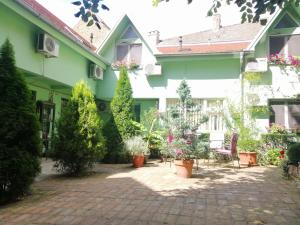 a courtyard of a house with potted plants at Fortress Apartments in Novi Sad