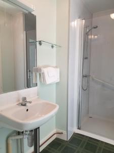 a bathroom with a sink and a shower at Corsewall Lighthouse Hotel in Kirkcolm +92 photos
