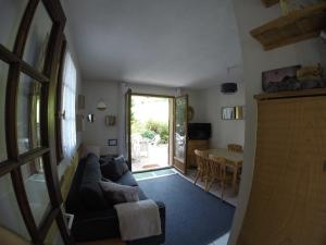 a living room with a couch and a table at 2 pièces avec terrasse Morillon Village in Morillon