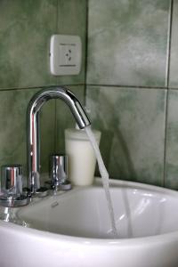 a sink with a faucet in a bathroom at B&B Mi Casa Es Tu Casa in Mar Azul +64 photos