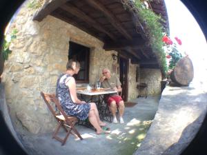 a man and a woman sitting at a table at Xuegu la bola in Ceceda de Abajo