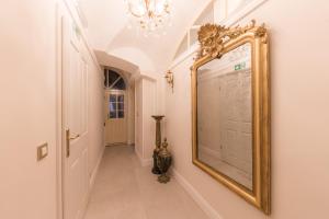a hallway with a large mirror on the wall at AB Ljubljana - The Residence in Ljubljana