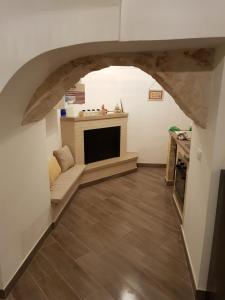 a living room with a couch and a fireplace at Casa Arco della Chicca in Monopoli