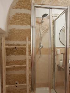 a shower with a glass door in a bathroom at Casa Arco della Chicca in Monopoli +13 photos
