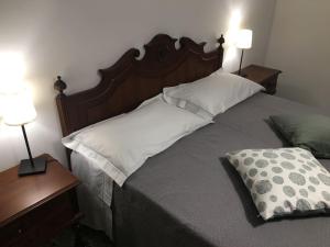 a bed with two pillows and two lamps in a bedroom at LA TERRAZZA DI MONTEROSSO in Monterosso al Mare +43 photos