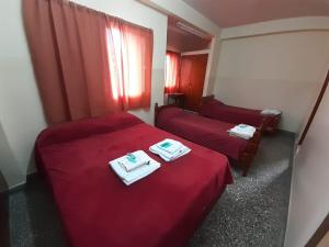 a hotel room with two beds with towels on them at Hotel Patricias 381 in San Salvador de Jujuy