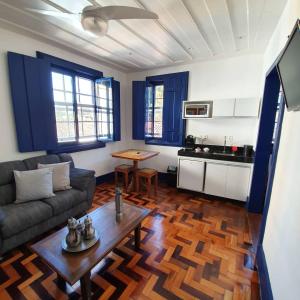 a living room with a couch and a table at Casa dos Meninos B&B in Ouro Preto