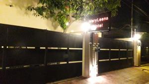 a gate with a sign in front of a building at MaryLeena Hotel Gulberg in Lahore