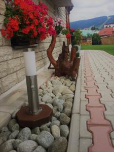 a candle sitting on a stone walkway with a bench at Apartmány Rejdovian in Telgárt