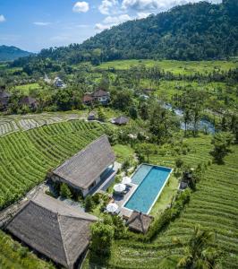 an aerial view of a villa with a swimming pool in a field at Villa Kropak in Sidemen