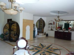 a room with a room with a mirror and a table at Villa Marquês in Vila Nova da Barquinha
