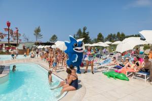 a group of people in a pool at a resort at Mobile Homes Camping Santa Marina, Lanterna in Poreč