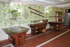 two sinks in a room with a wall with flowers at Hotel El Guerra in Güéjar-Sierra