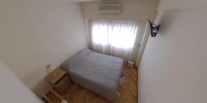 ein kleines Schlafzimmer mit einem Bett und einem Fenster in der Unterkunft Dpto. 2 ambientes en Belgrano - FLENI & Barrio Chino in Buenos Aires
