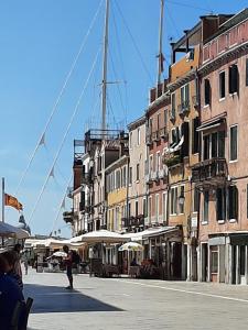 a group of buildings with umbrellas on a city street at ISEPO APARTMENT in Venice
