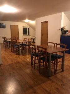 a dining room with wooden tables and chairs at Sobe Matea - prenoćište in Vinkovci +11 photos