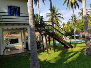 a staircase leading up to a house with palm trees at Rancho villas de alicia in La Paz